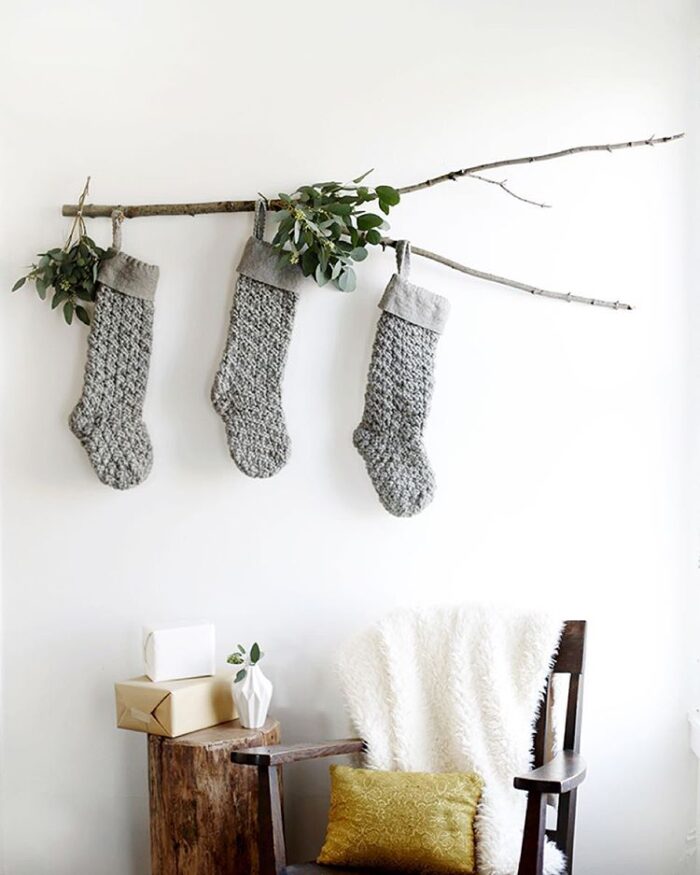 Christmas stockings hanging from a branch -when you don't have a mantel