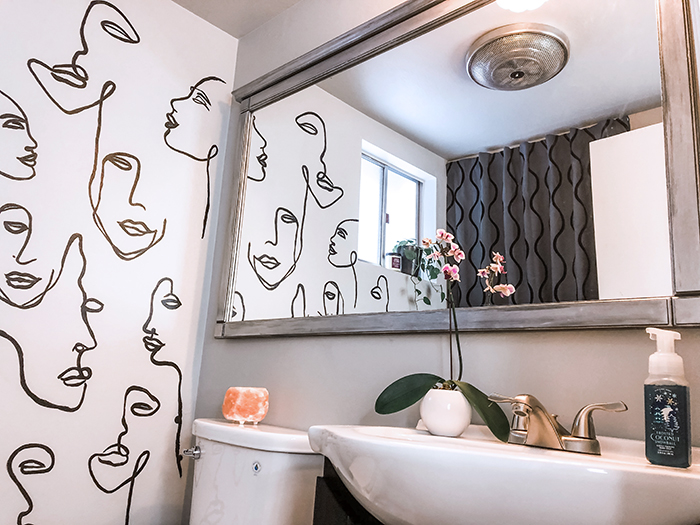 before and after small bathroom makeover with hand painted wall line art faces on the wall, wall paper alternative, drawing on walls, wall mural, accent walls