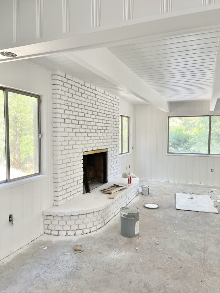 painted white interior, painted brick fireplace mantel, 60s lake house in lake arrowhead, z painting