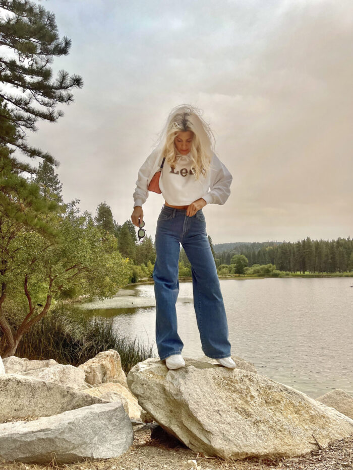 lee, lee jeans, 90s look, cropped hoodie sweatshirt, high rise a line wide leg jeans, nikes, denim, lake arrowhead, pretty sky, nature, girl standing in front of a lake