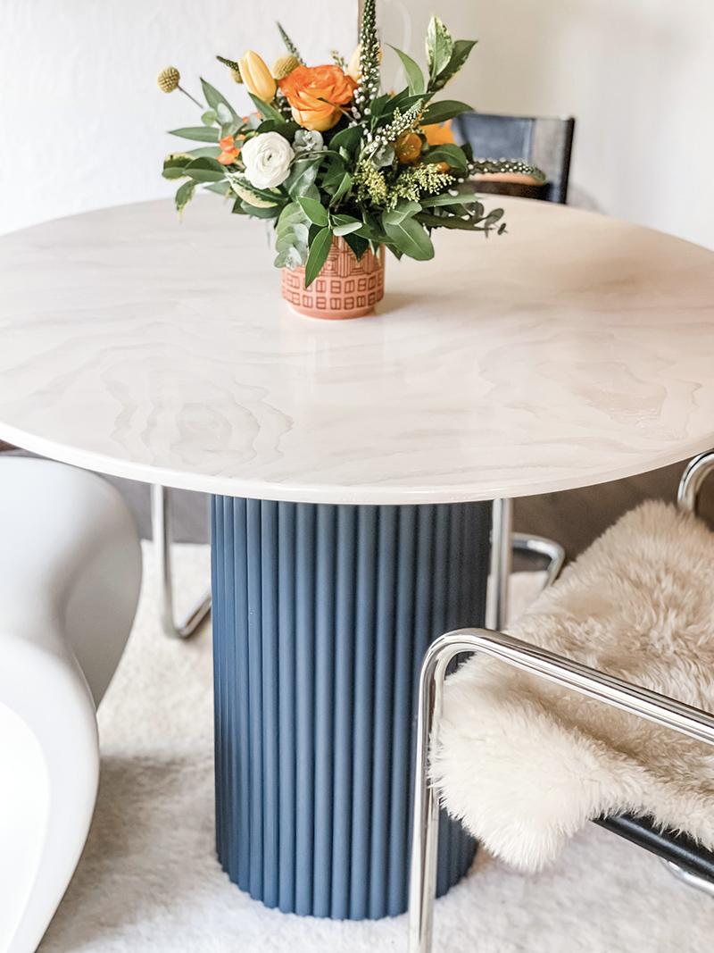 DIY modern round kitchen dining room table with contrasting base and marble like wood top, modern round dining table with chrome chairs, breuer chairs, stam chairs, panton