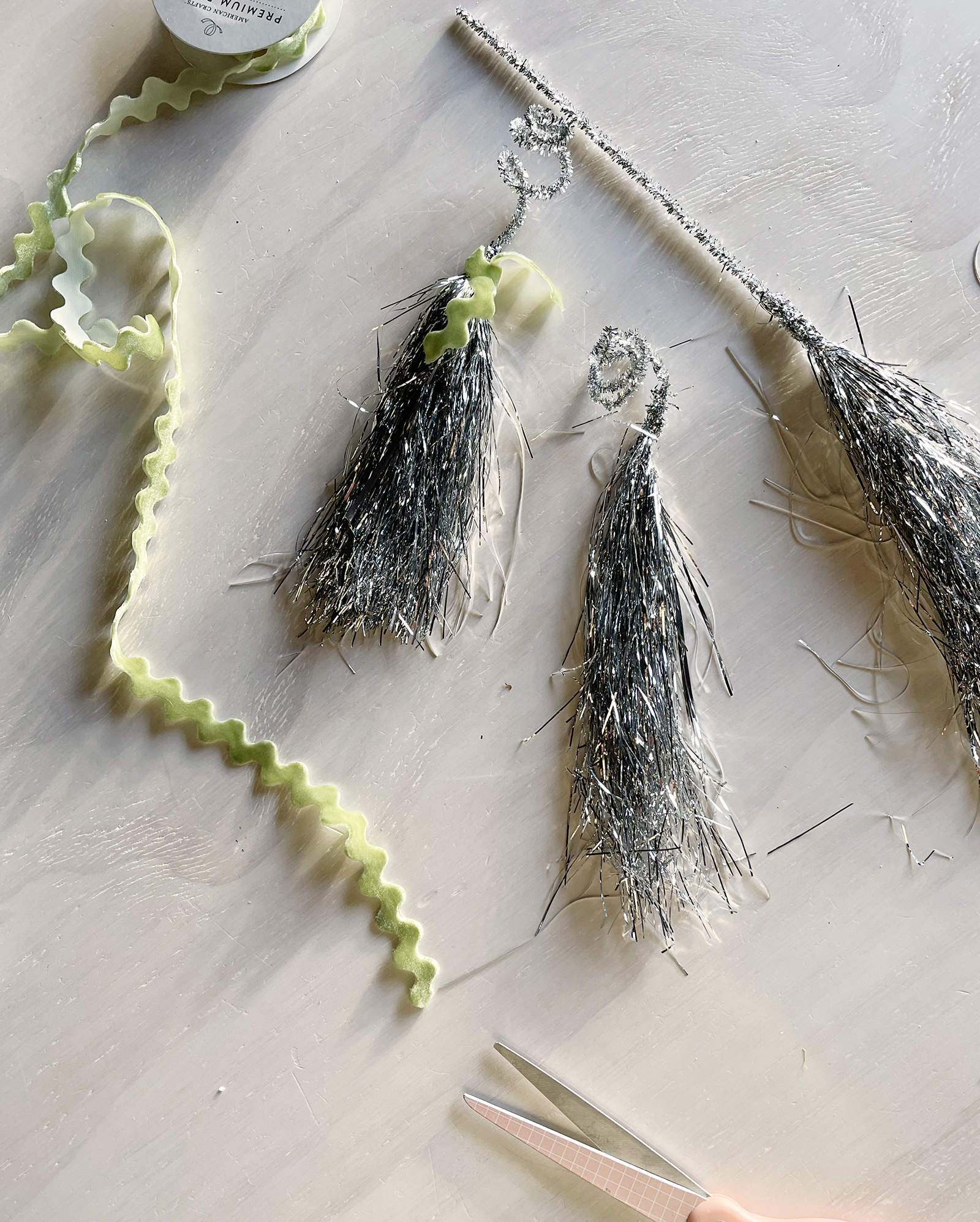 how to recycle and reuse your christmas tree tinsel into tassels for ornaments or gift wrapping or party decor