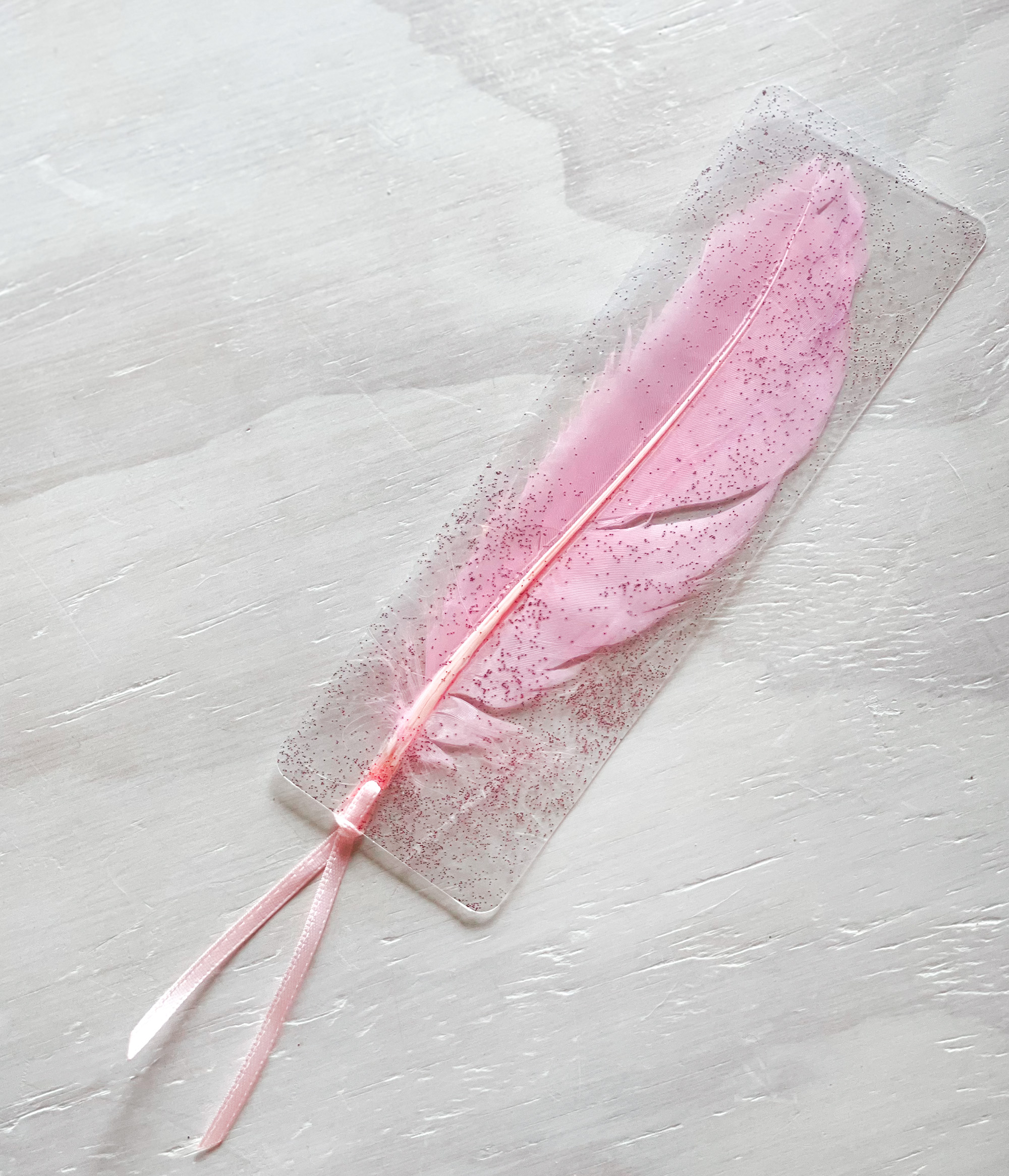 pretty pastel pink feather bookmark with pink ribbon