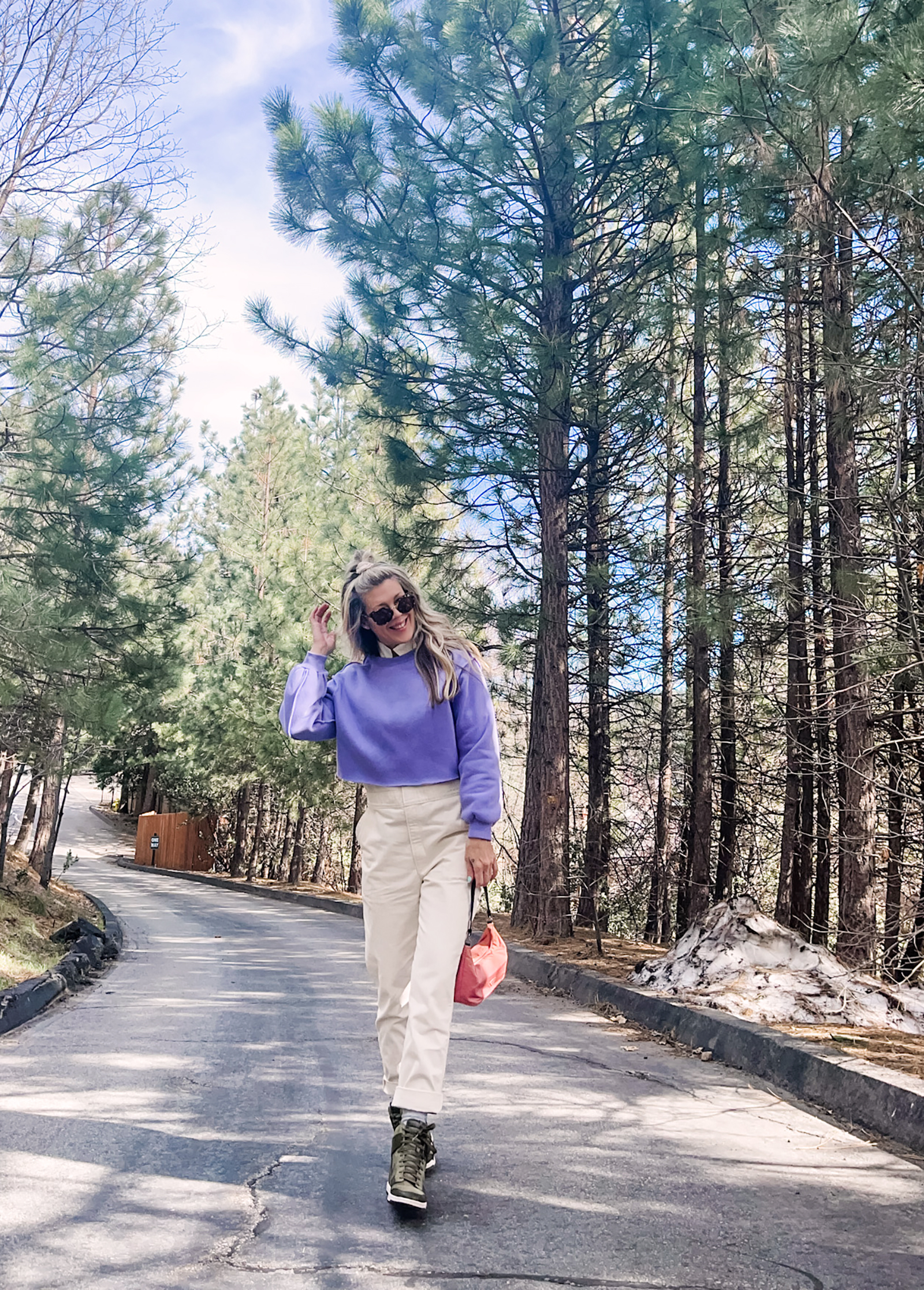 cute spring style in coveralls, lee jeans union-alls jumpsuit in ivory with lavender cropped sweatshirt, pink prada bag and nike sky high sneakers