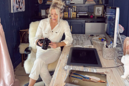 ivory unionalls sitting at desk in office