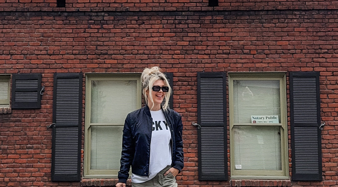 casual style wearing army green military pants-cargos-oversized baggy t-shirt-navy bomber jacket-puma palermo-alexander wang bag