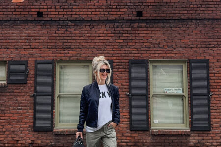 casual style wearing army green military pants-cargos-oversized baggy t-shirt-navy bomber jacket-puma palermo-alexander wang bag