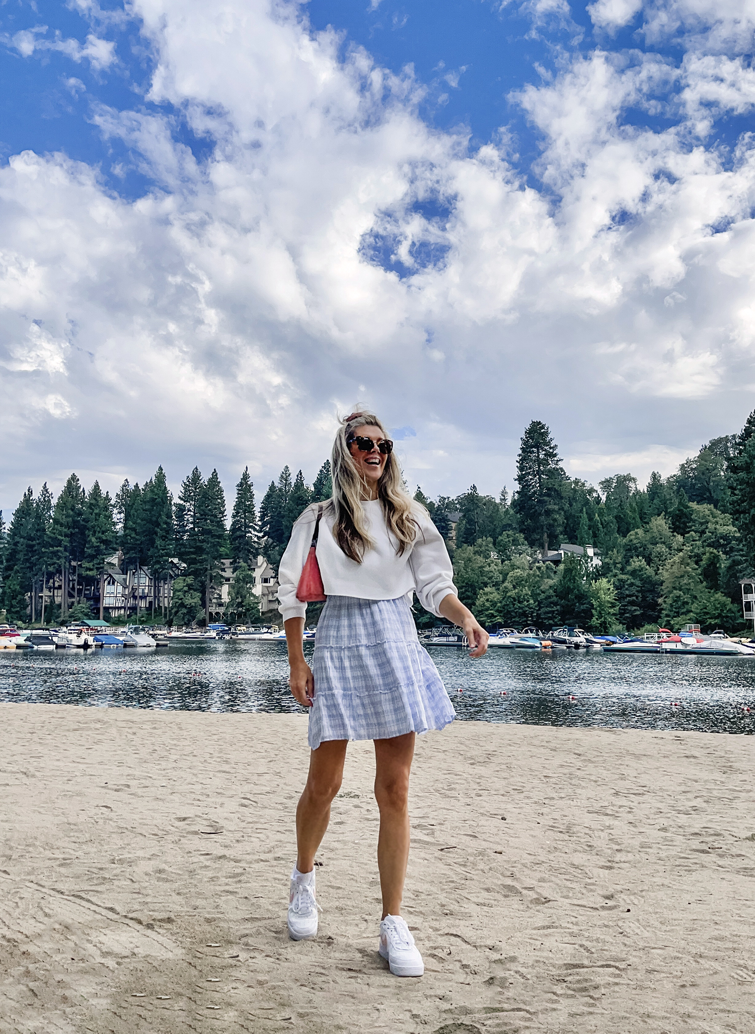 late summer outfit on the lake, cloudy sky, lake arrowhead, light blue plaid dress with sneakers, nikes, vintage prada bag