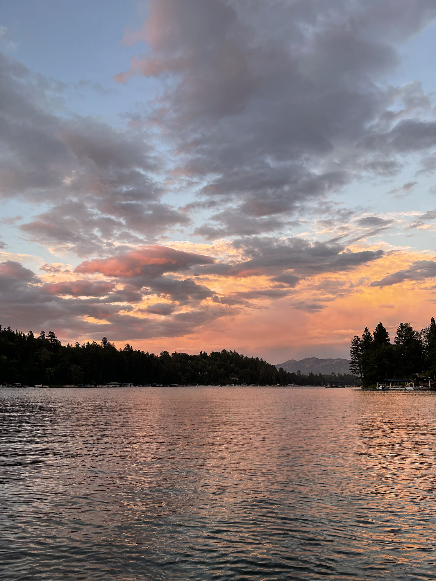 pink sunset with clouds at dusk over the lake