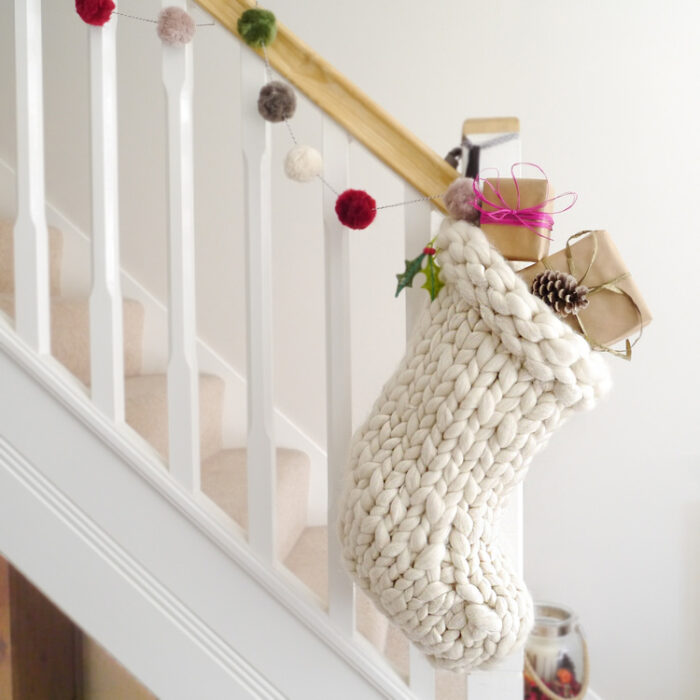knit christmas stocking hanging from the banister
