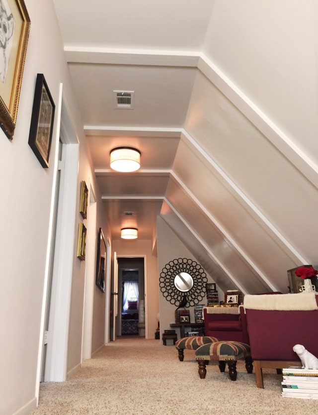 long hallway-slanted ceiling-sitting area